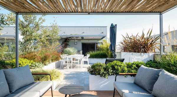 A landscape designers renovates a pool space in a garden in Annecy